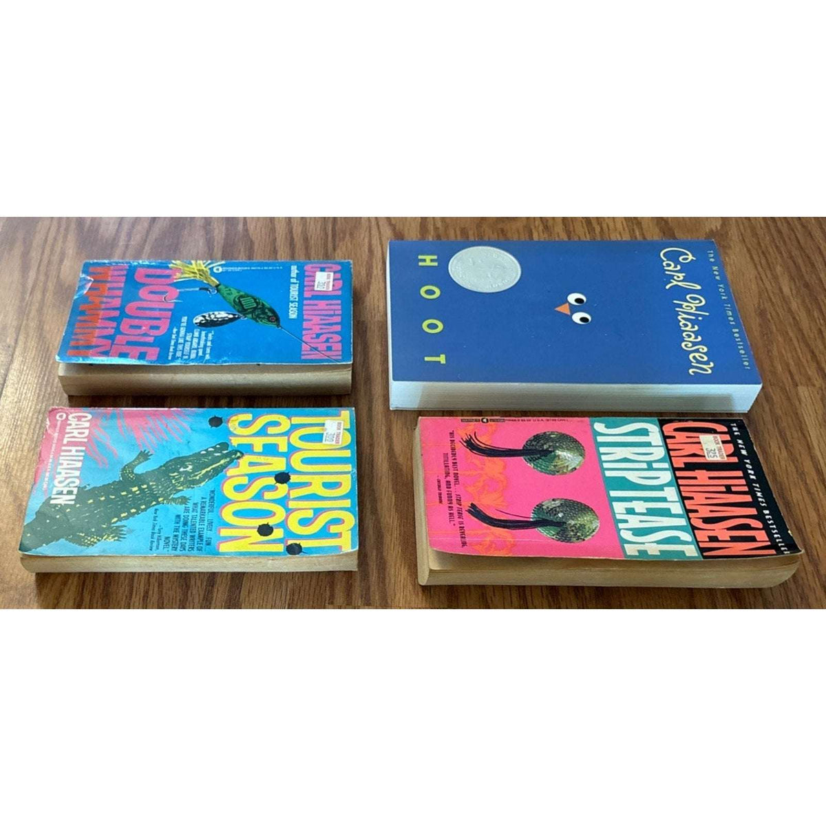 Set of 4 Paperbacks by Carl Hiaasen - Tourist Season, Hoot, Strip Tease, Double Whammy